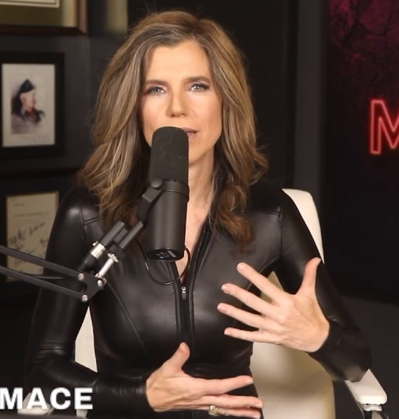 Nancy Mace gesturing mid-segment in the black leather catsuit with matching gloves, September 25, 2026